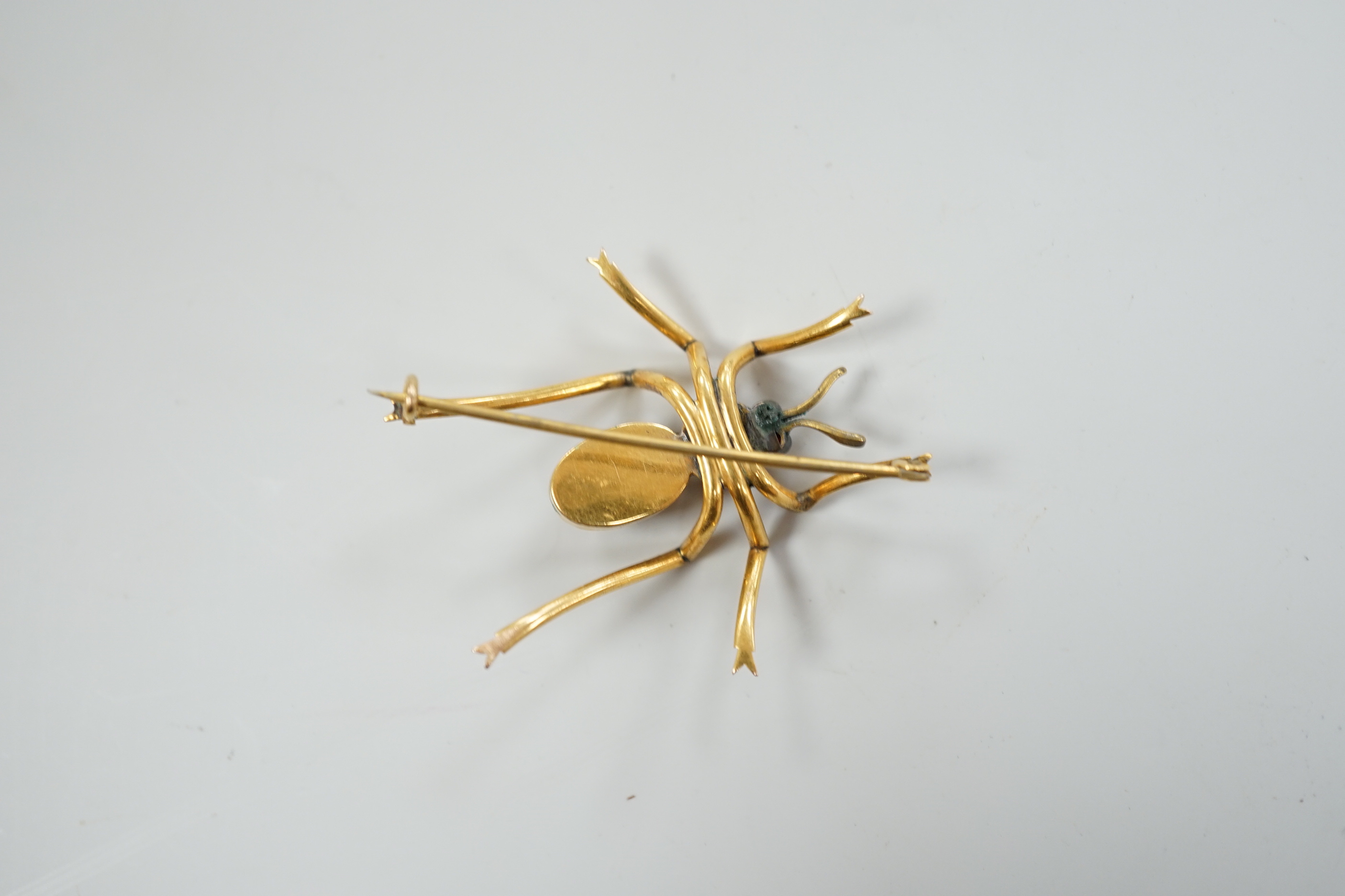 A yellow metal, tiger's eye quartz and gem set spider brooch, 41mm, gross weight 6.1 grams.